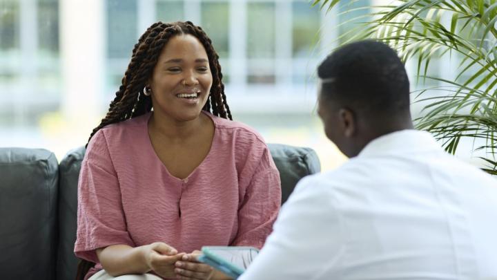 Two people meeting to discuss health care services and patient-centered care.