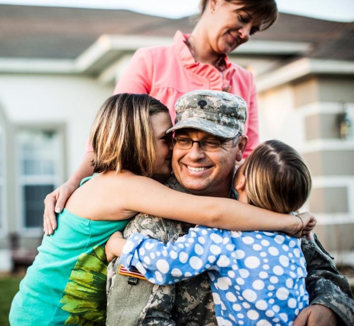 Veteran reconnecting with family members at home, representing emotional support and overall well-being.
