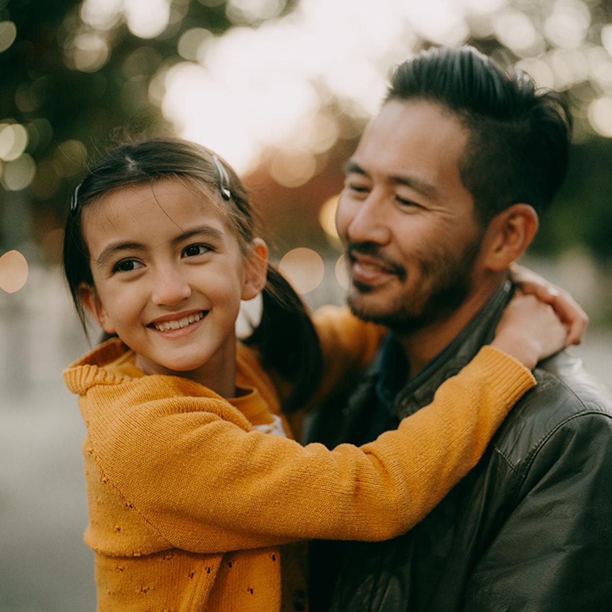 Father holding daughter